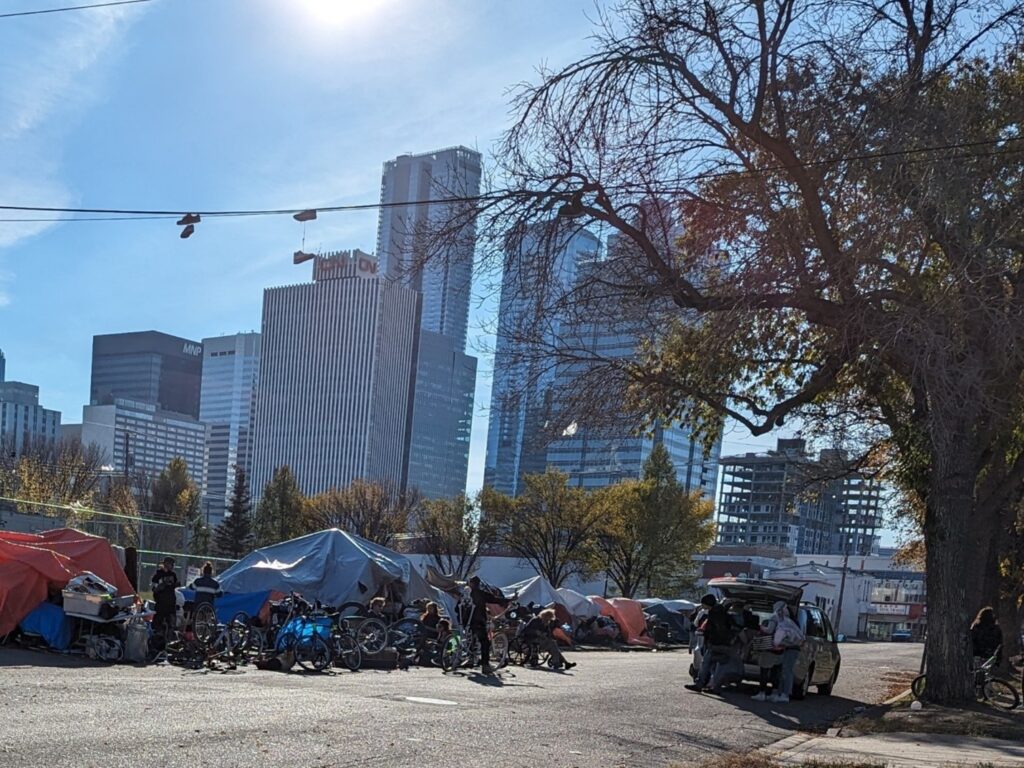 A tent city with a collection of bicycles
